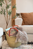 Large U Shopper basket with blanket and book in living room
